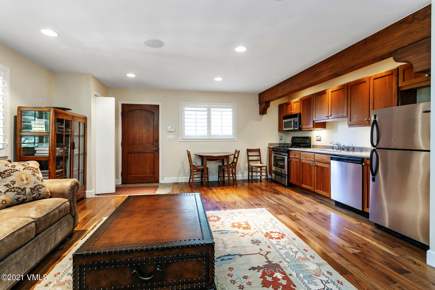 850 Eagle Drive Eagle-Vail, CO 81620 - Photo 37 of 44 a large kitchen with stainless steel appliances granite countertop a refrigerator a stove and a dining table with wooden floor