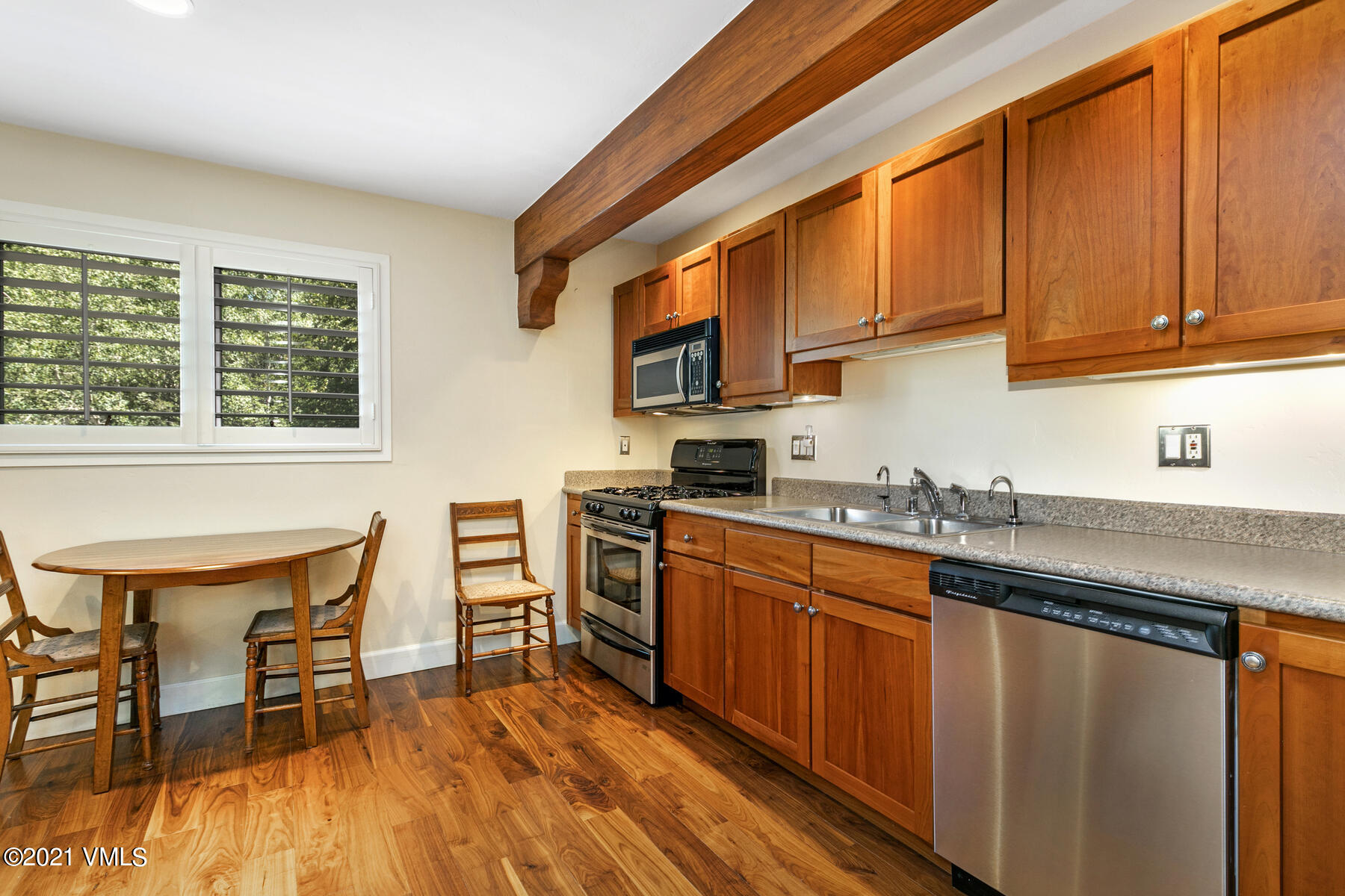 850 Eagle Drive Eagle-Vail, CO 81620 - Photo 38 of 44 a kitchen with stainless steel appliances granite countertop a stove top oven a sink dishwasher and cabinets with wooden floor