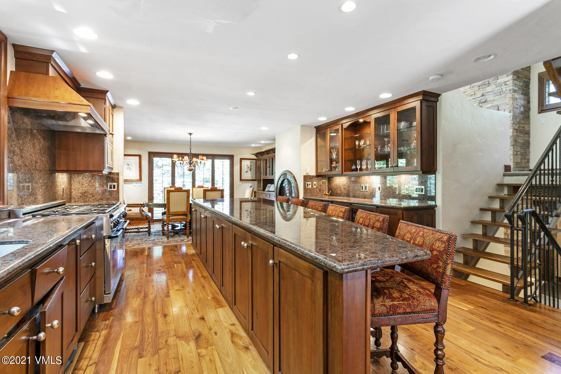 850 Eagle Drive Eagle-Vail, CO 81620 - Photo 7 of 44 a kitchen with stainless steel appliances granite countertop a stove top oven a sink a dining table and chairs with wooden floor