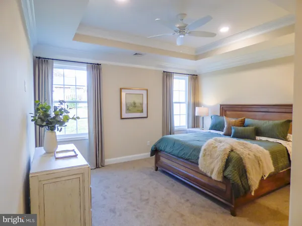a bedroom with a bed and a potted plant