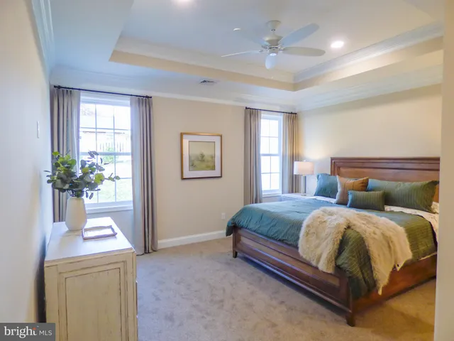 a bedroom with a bed and a potted plant