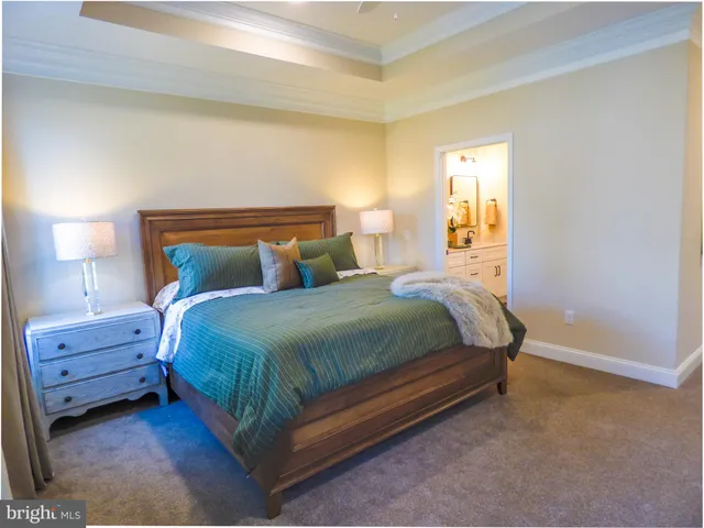 a bedroom with a bed and lamp