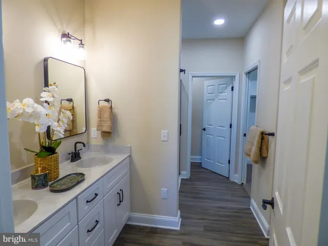 a bathroom with a double vanity sink and a mirror