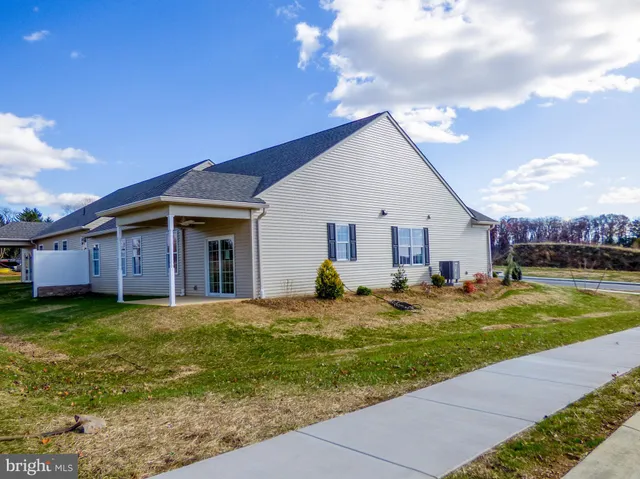 a view of a house with a yard and swimming pool