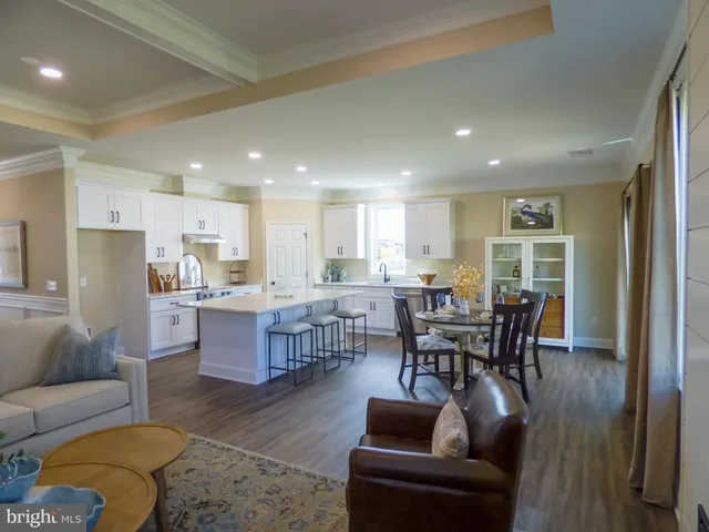 a living room with furniture and kitchen view