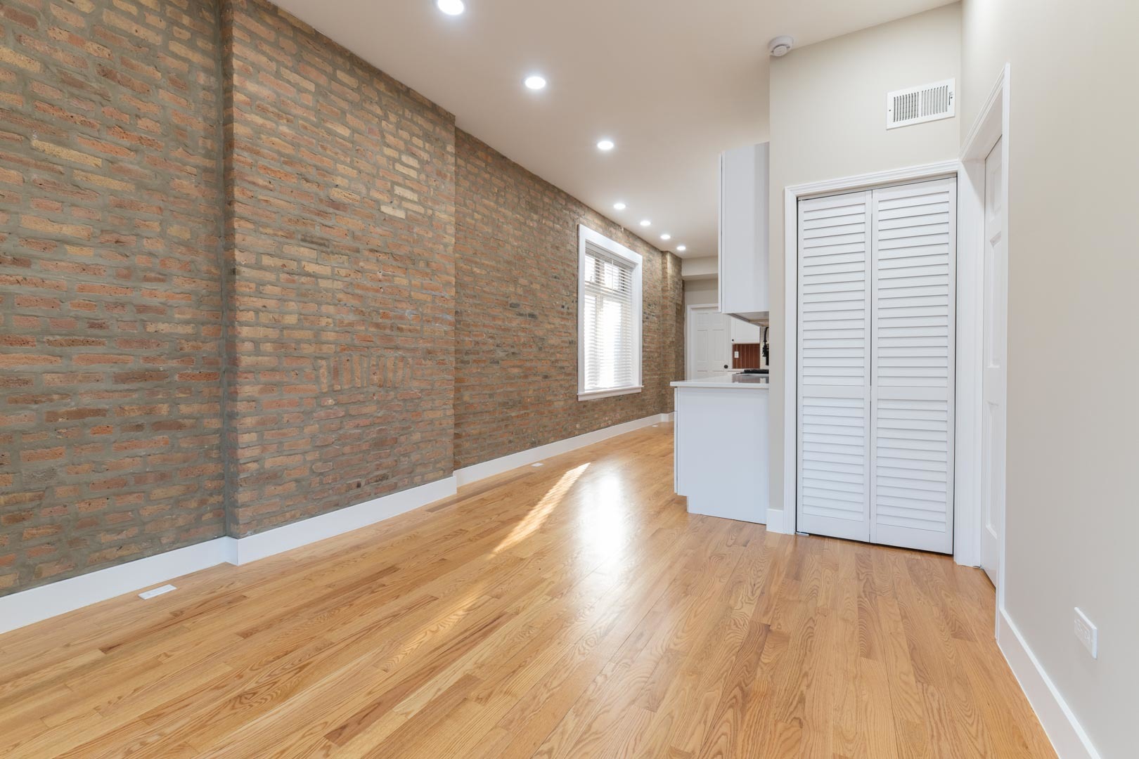 1303 West Flournoy Street, Unit 2F Chicago, IL 60607 - Photo 3 of 16 a view of a hallway with wooden floor