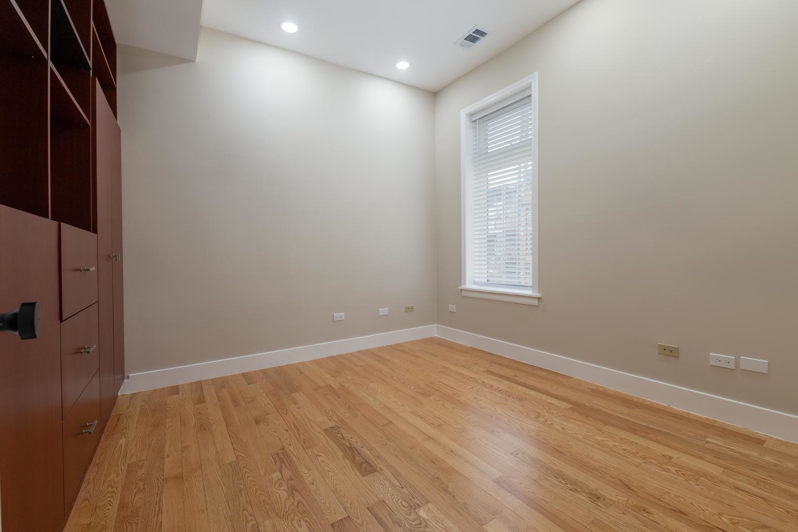 1303 West Flournoy Street, Unit 2F Chicago, IL 60607 - Photo 8 of 16 a view of an empty room with wooden floor and a window