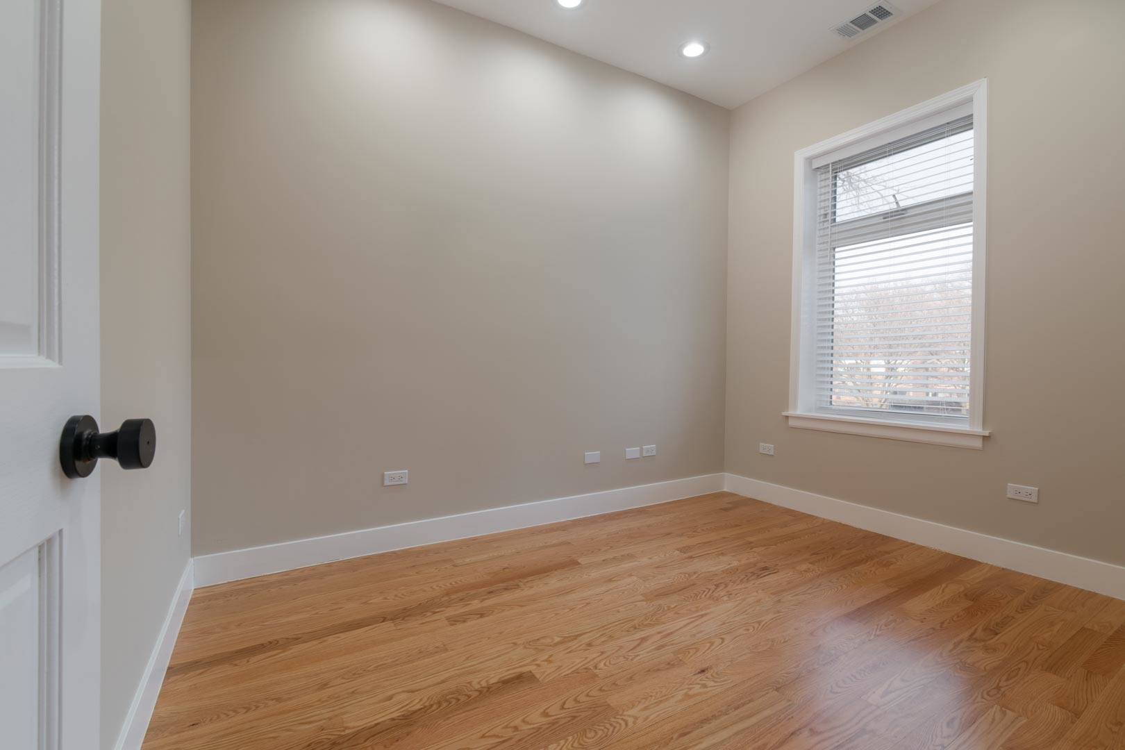 1303 West Flournoy Street, Unit 2F Chicago, IL 60607 - Photo 9 of 16 wooden floor in an empty room with a window