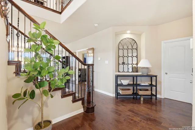 a view of hall way with furniture and a potted plant
