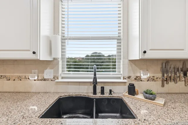a kitchen with a sink cabinets and window