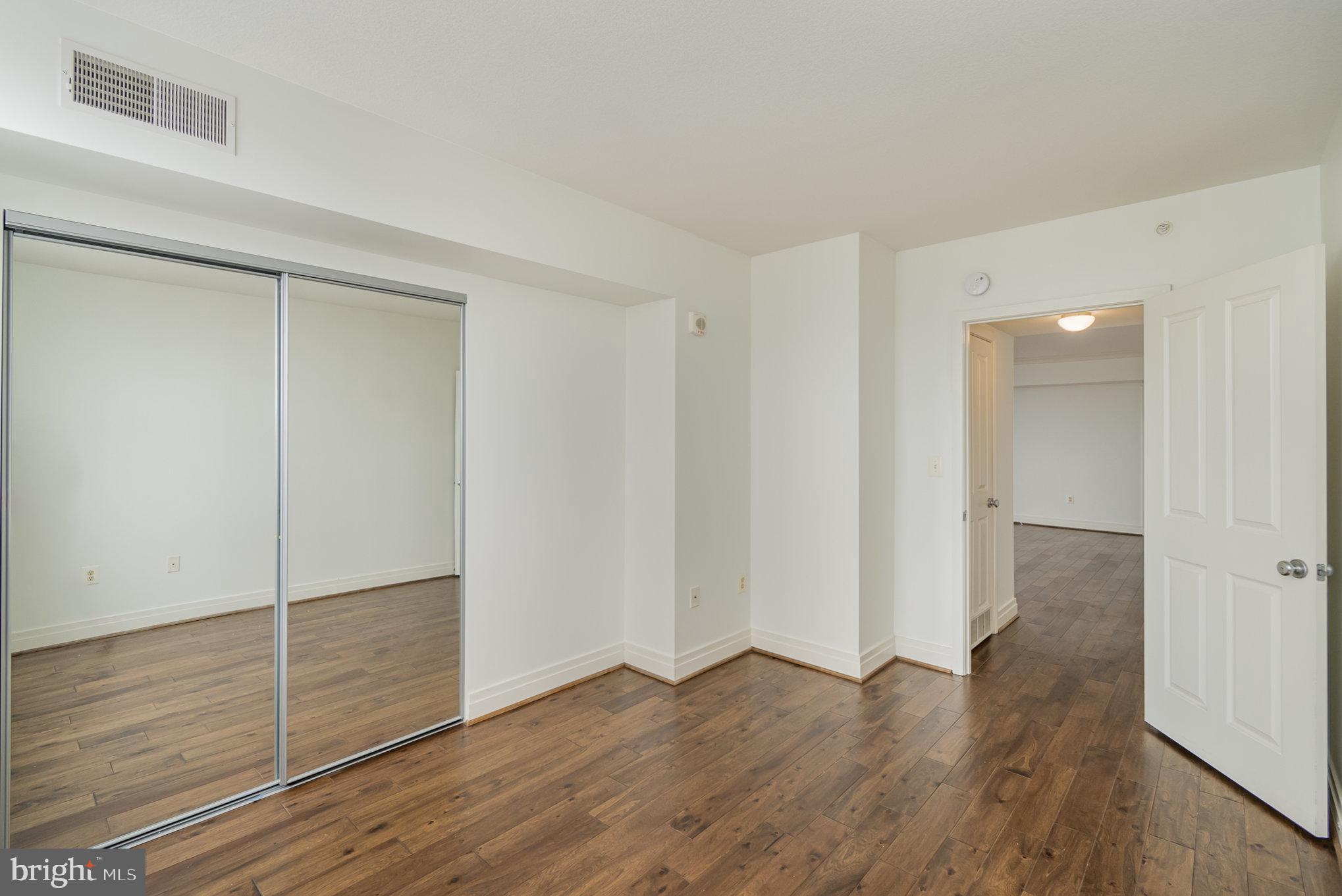 414 Water Street, Unit 1512 Baltimore, MD 21202 - Photo 17 of 28 wooden floor in an empty room