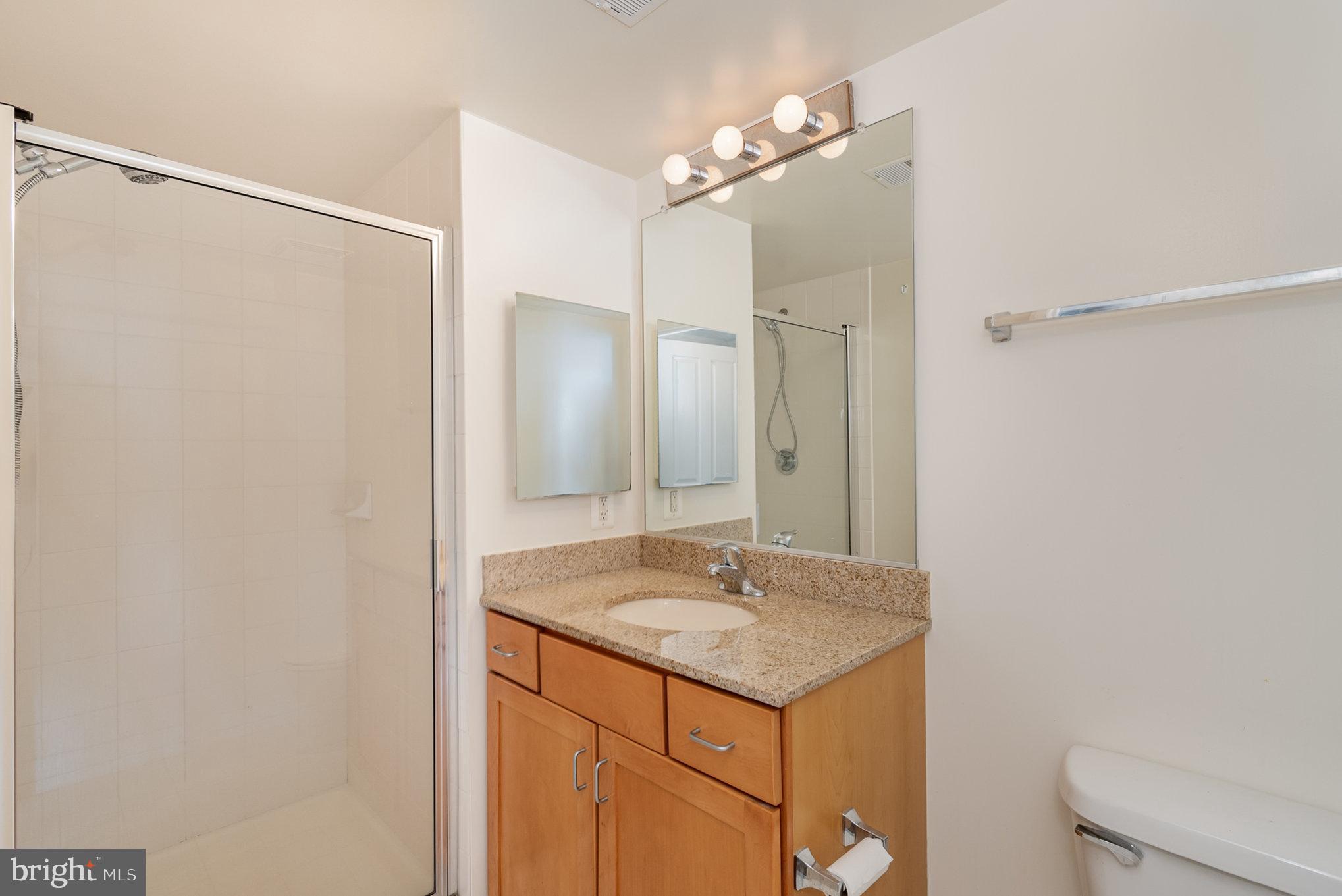 414 Water Street, Unit 1512 Baltimore, MD 21202 - Photo 18 of 28 a bathroom with a sink and a mirror