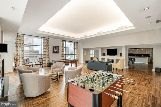 a kitchen with stainless steel appliances granite countertop a stove and a wooden floors
