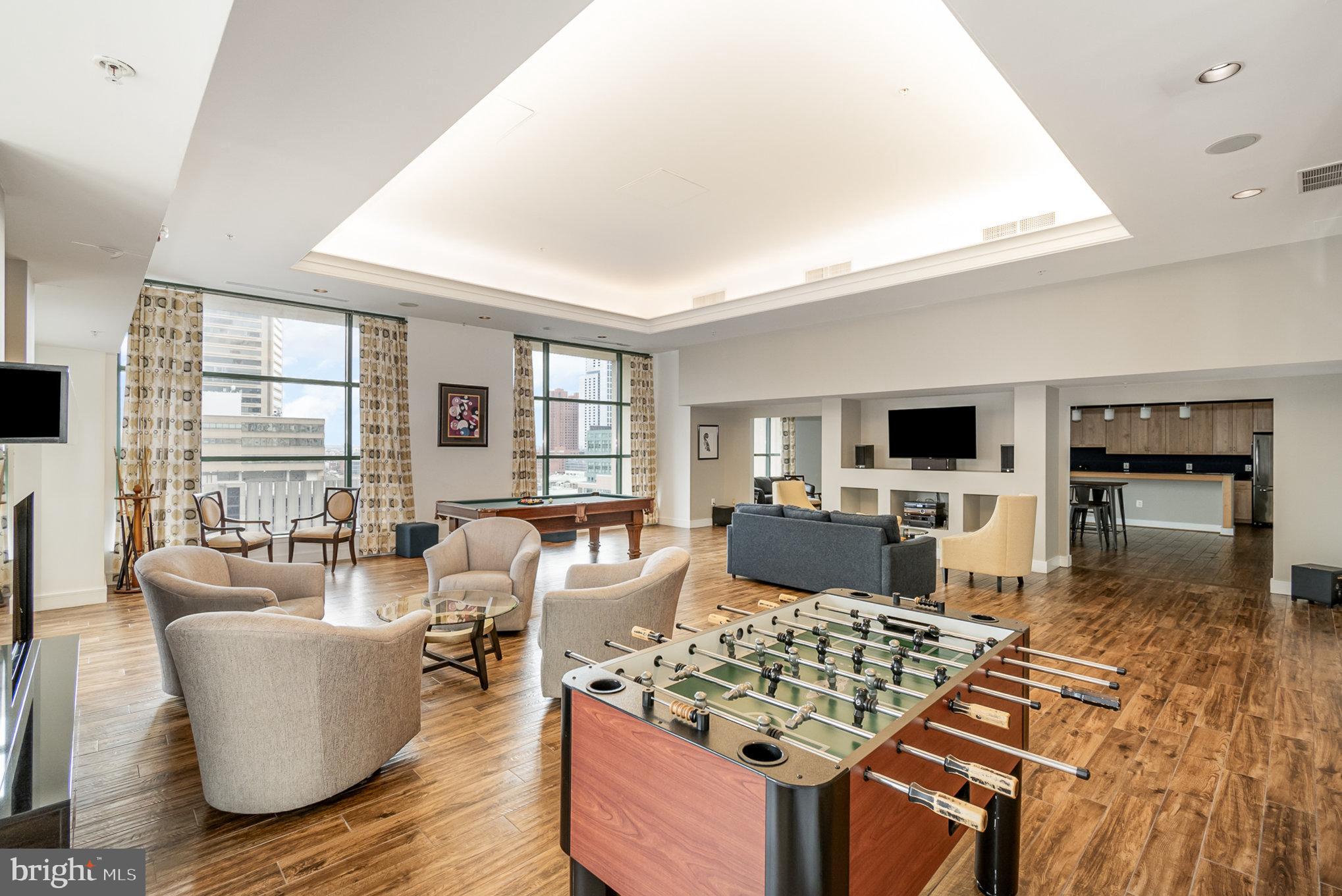 414 Water Street, Unit 1512 Baltimore, MD 21202 - Photo 25 of 28 a living room with furniture and a flat screen tv