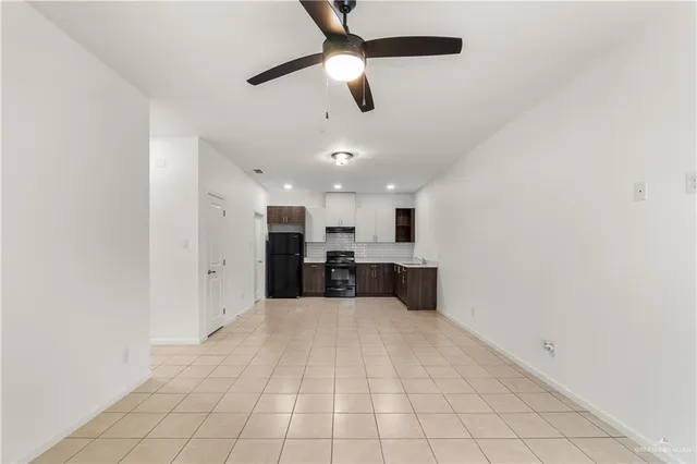 a view of a kitchen with furniture and a ceiling fan