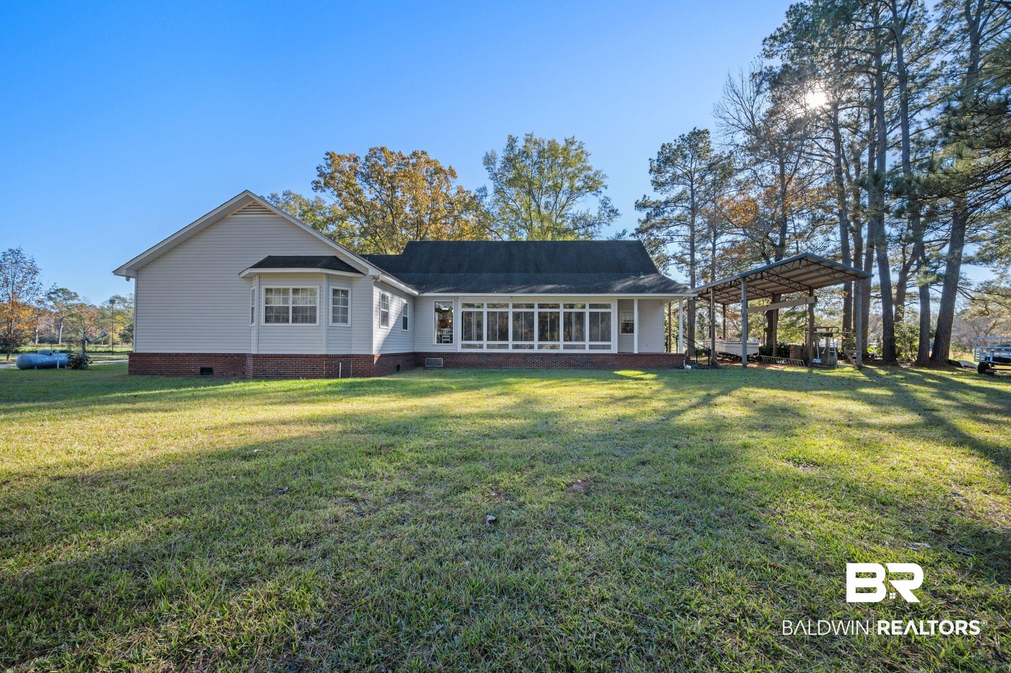 15801 Maytower Road Bay Minette, AL 36507 - Photo 34 of 43 Back of house with a carport and a yard
