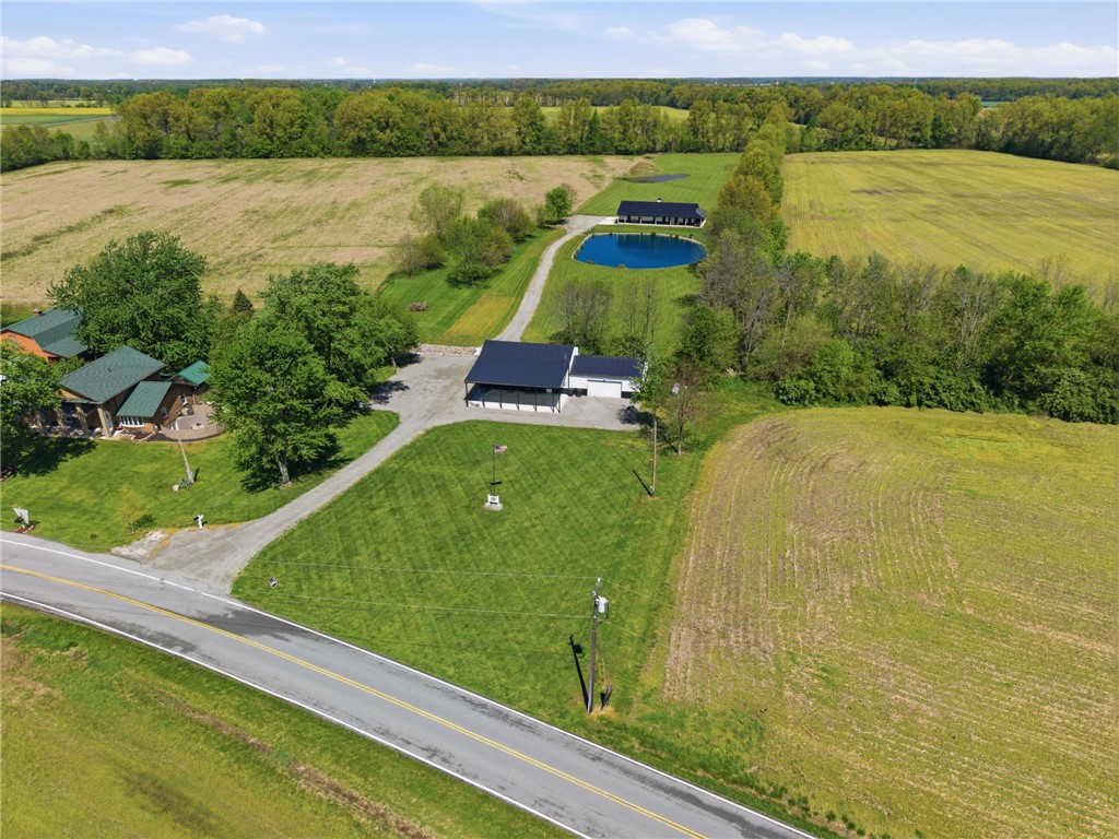 1602 Westboro Road Blanchester, OH 45107 - Photo 59 of 81 This aerial view showcases a peaceful estate with multiple structures, lush greenery, and serene pond.