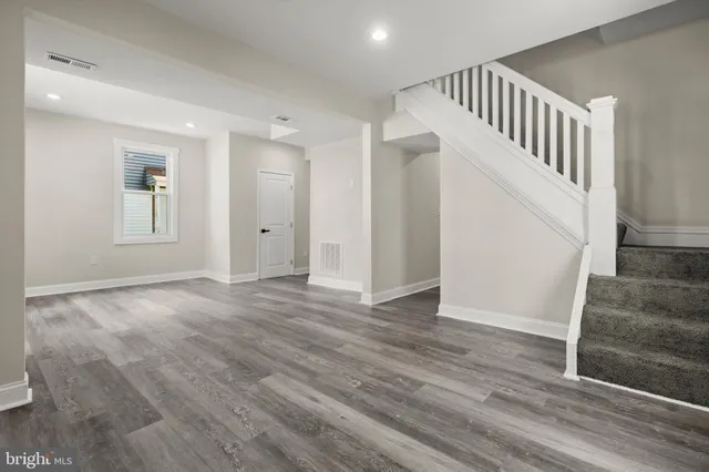 a view of an entryway with wooden floor