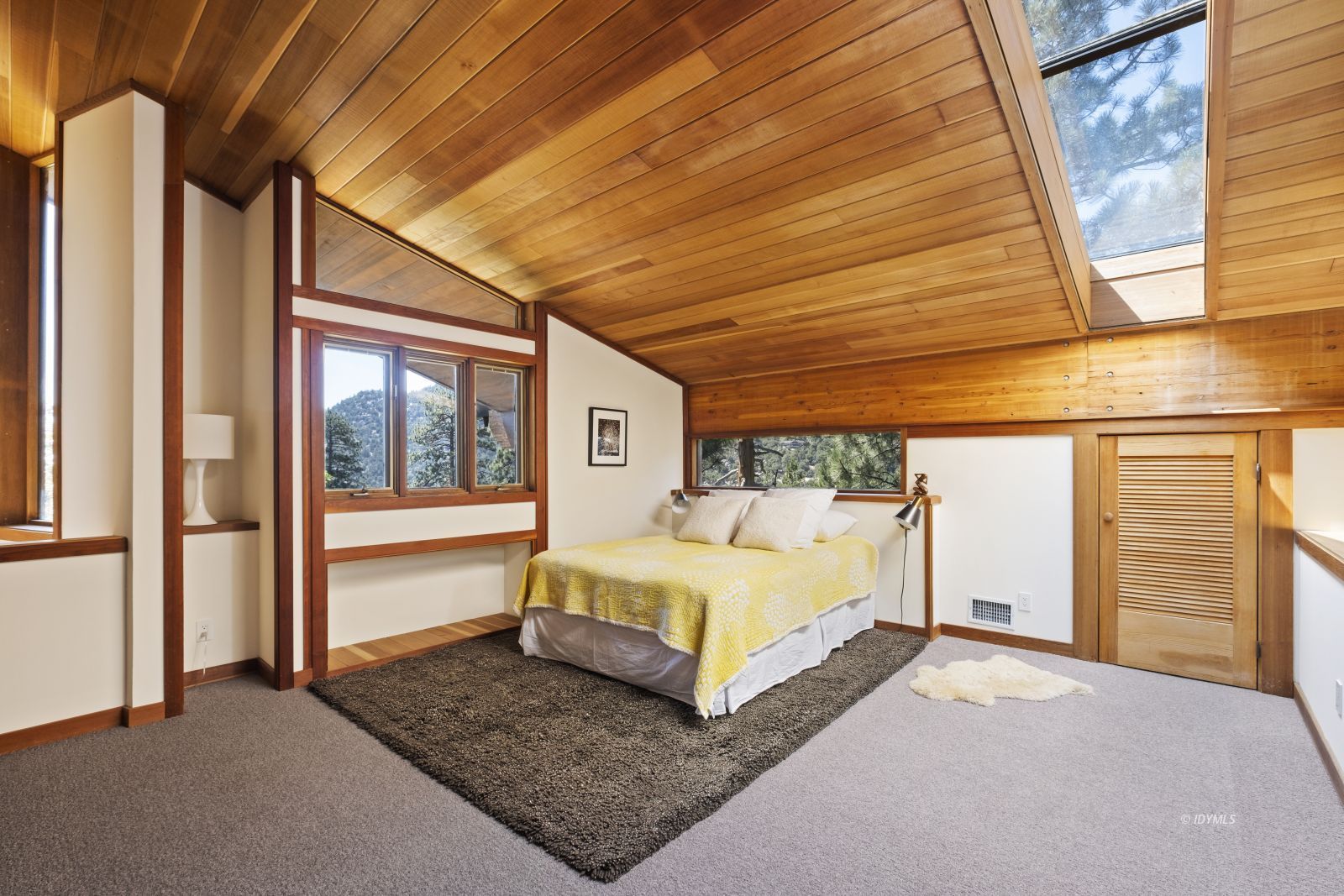 55526 Howland Road Idyllwild, CA 92549 - Photo 16 of 22 a spacious bedroom with a bed and a large window