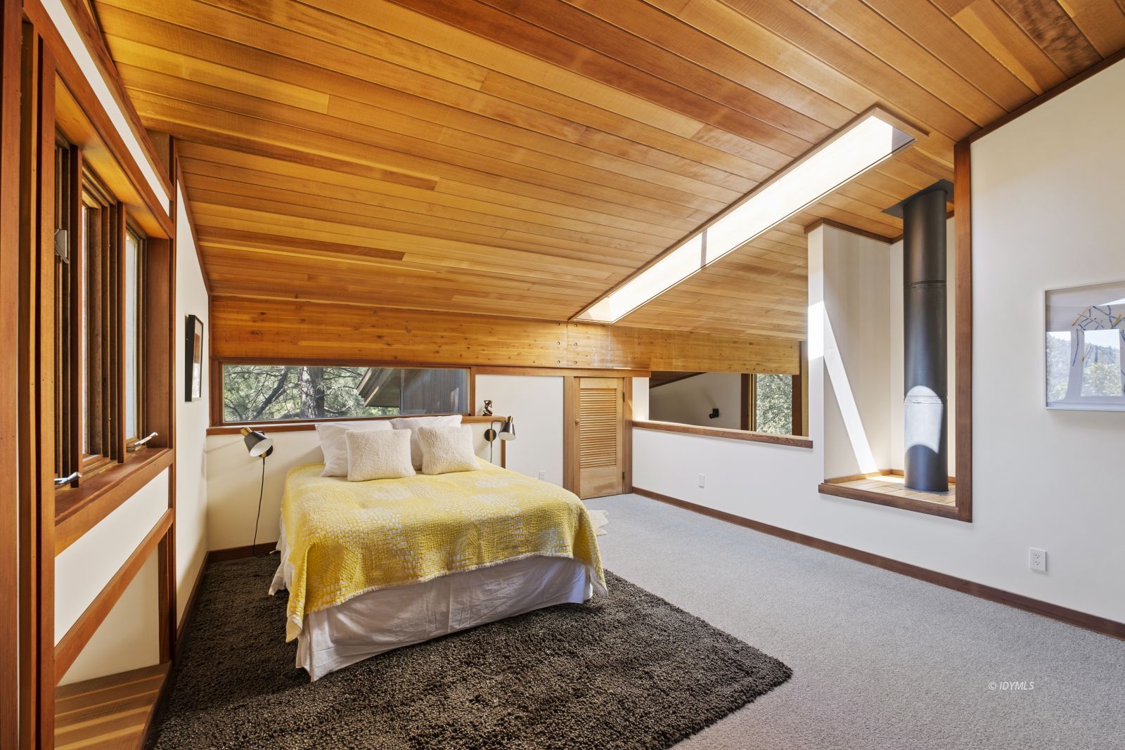 55526 Howland Road Idyllwild, CA 92549 - Photo 17 of 22 a bedroom with a bed a mirror and next to a window