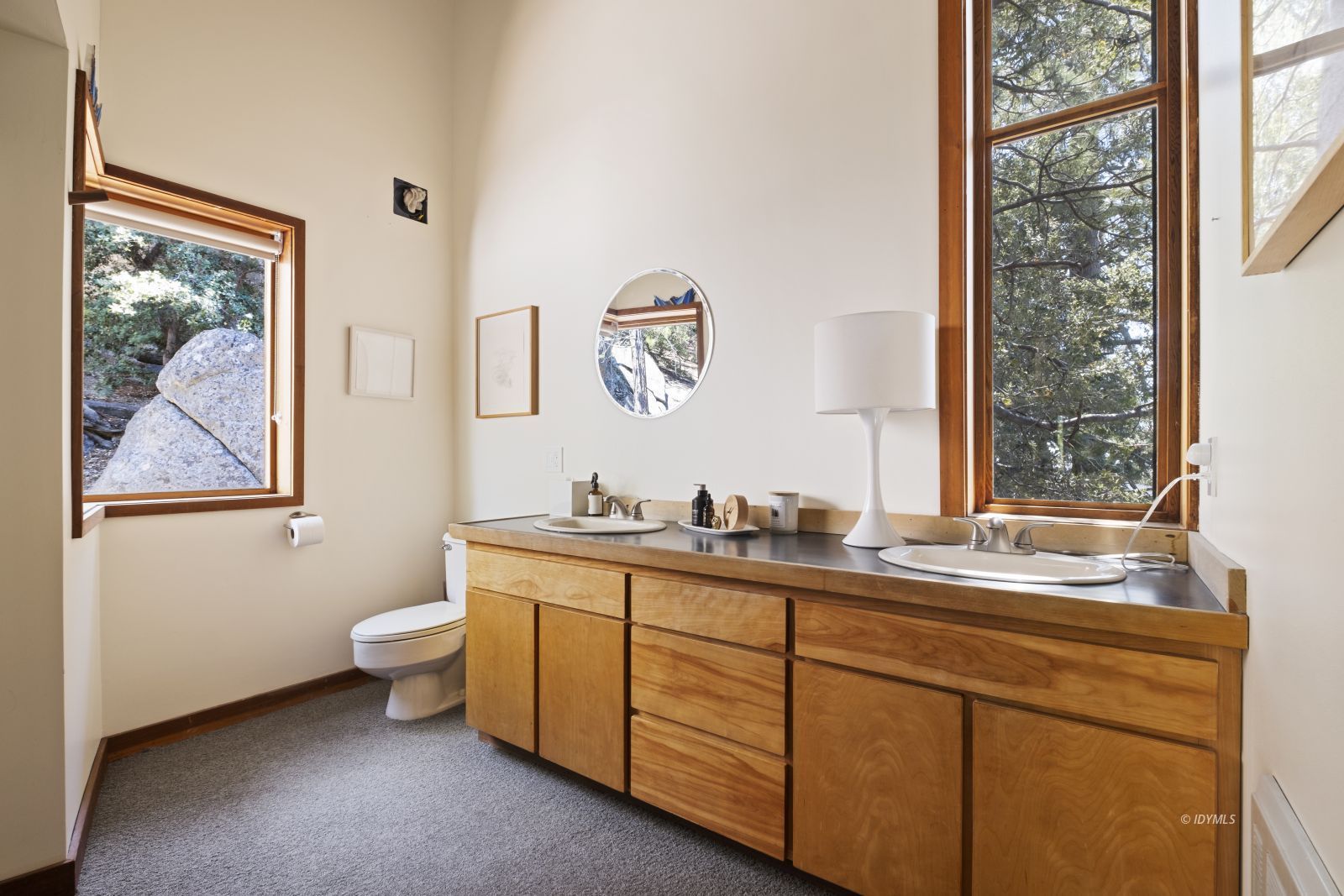 55526 Howland Road Idyllwild, CA 92549 - Photo 18 of 22 a spacious bathroom with a granite countertop sink a large mirror and a window