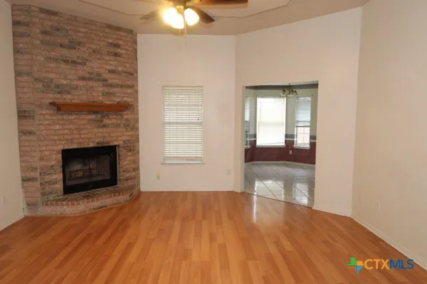 a view of a room wooden floor and a fireplace