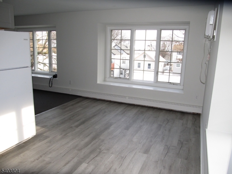 119 Valley Road Clifton, NJ 07013 - Photo 4 of 7 an empty room with wooden floor and windows