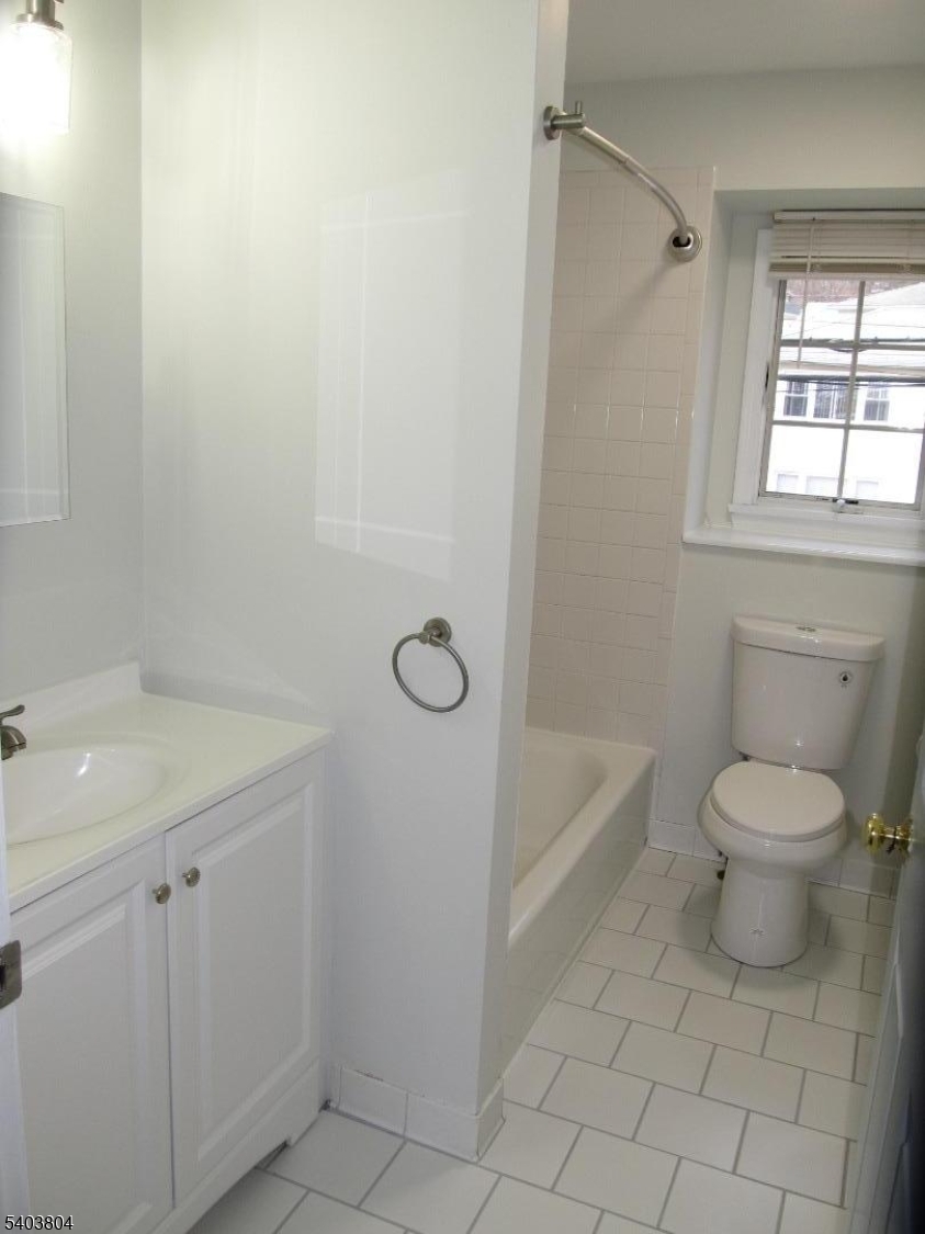 119 Valley Road Clifton, NJ 07013 - Photo 6 of 7 a bathroom with a sink a toilet and shower