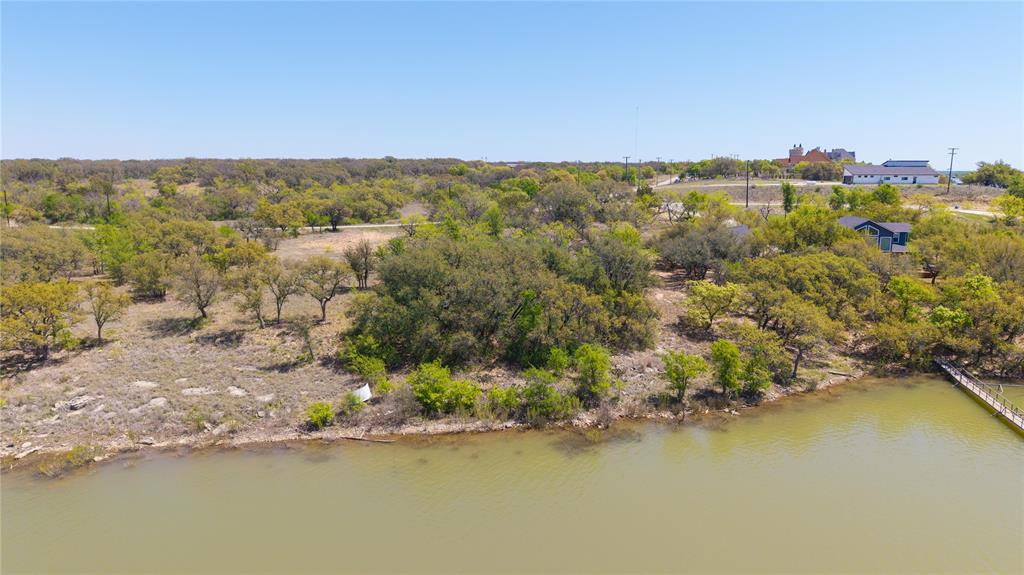 Bird's eye view of a nearby body of water and a tree filled landscape
