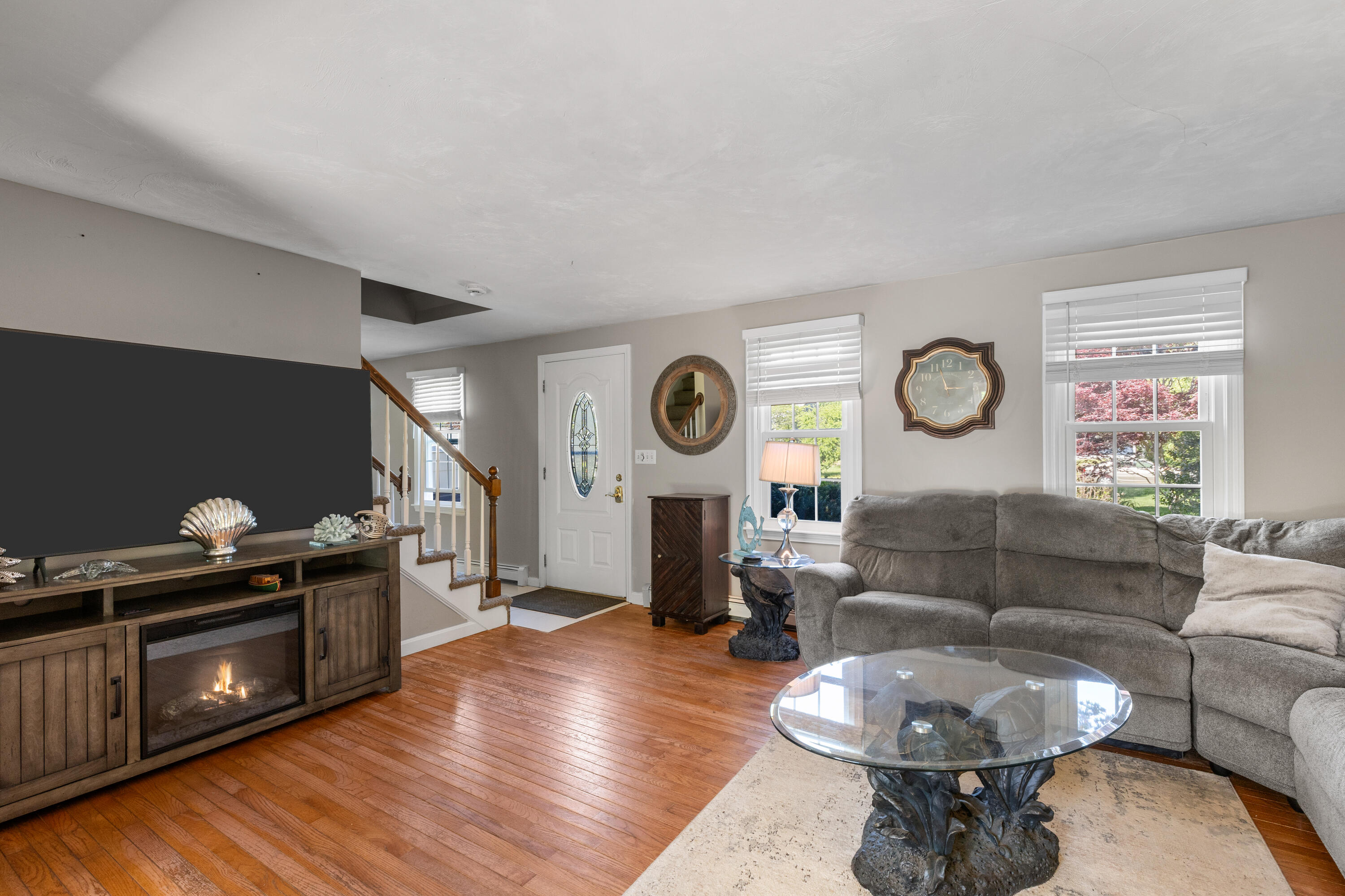 30 Sheffield Place Mashpee, MA 02649 - Photo 7 of 38 a living room with furniture a clock and a fireplace