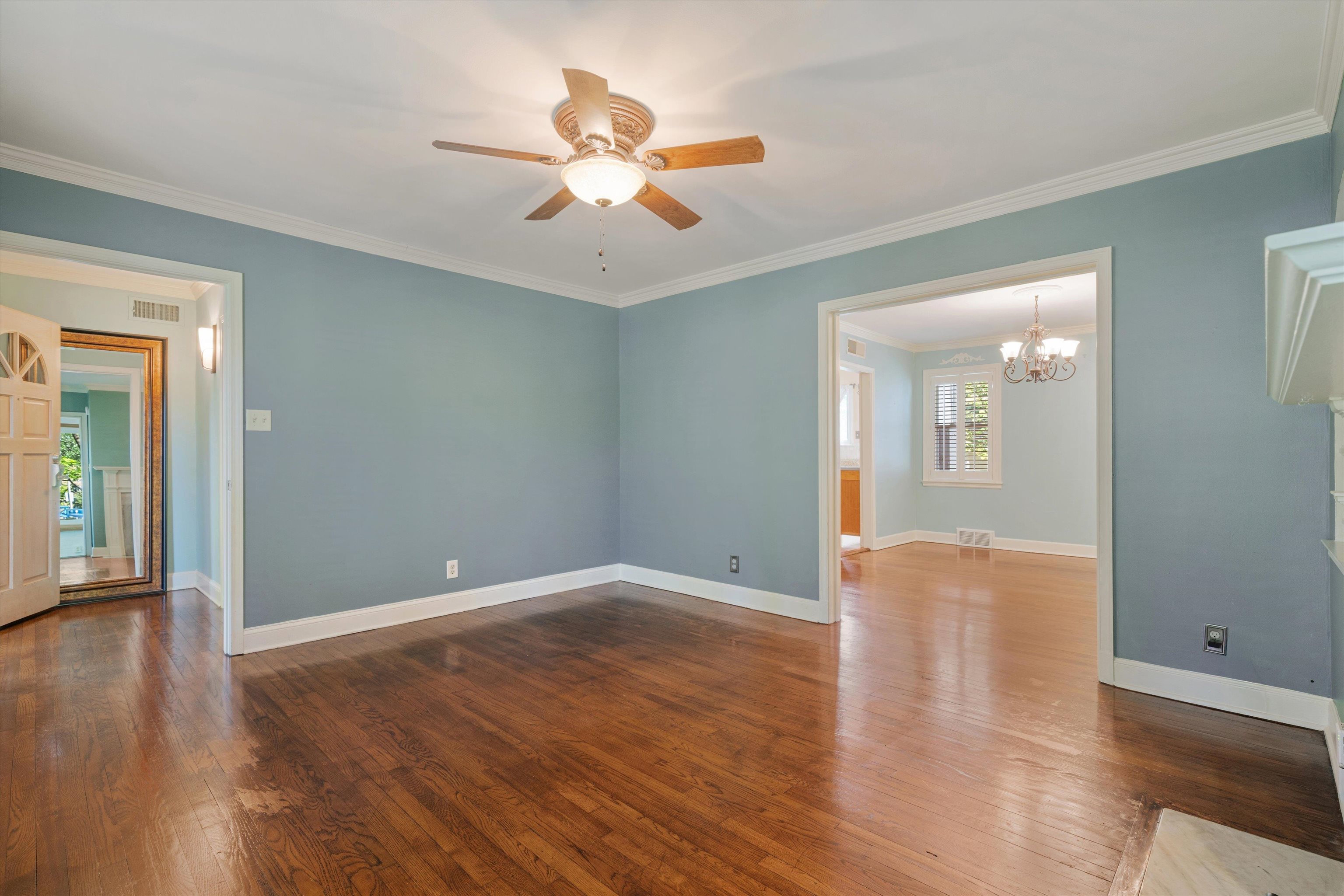 41 North Ashlawn Road Memphis, TN 38112 - Photo 8 of 26 Spare room featuring ornamental molding, dark wood-style floors, a chandelier, and a ceiling fan
