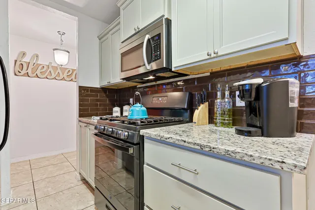 a kitchen with granite countertop cabinets and steel stainless steel appliances