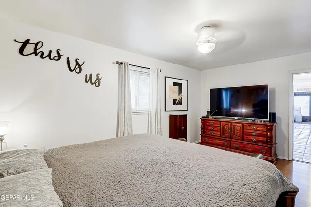 a bedroom with a bed and a flat screen tv