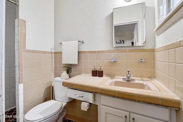 a bathroom with a sink toilet and mirror
