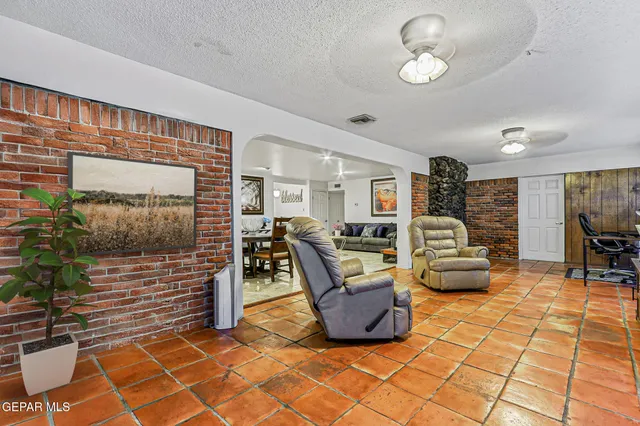 a living room with furniture a flat screen tv and rug