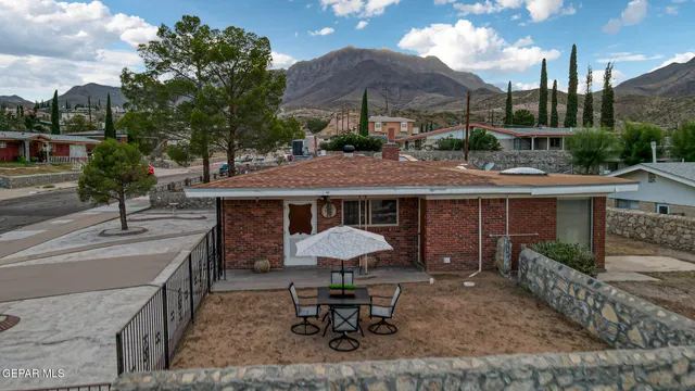 a view of a house with backyard and sitting area