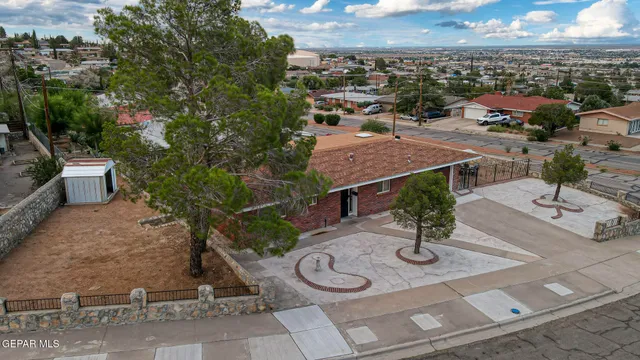 an aerial view of a house with garden space and street view