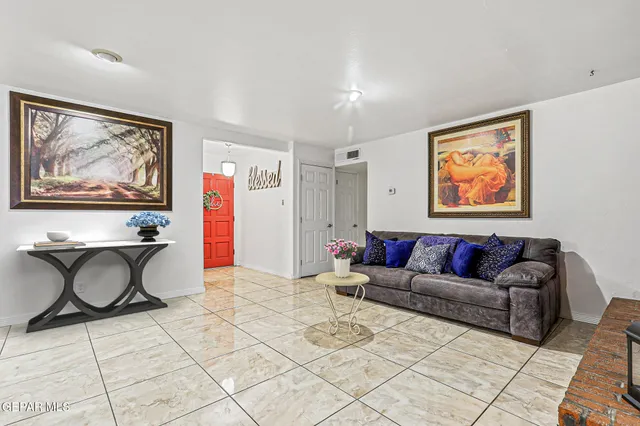 a living room with furniture and wall paintings