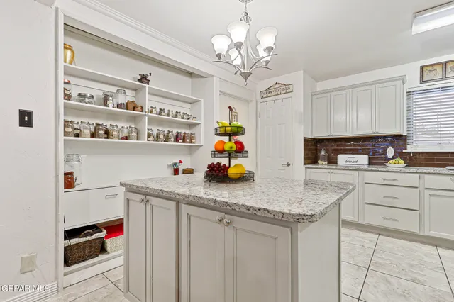 a kitchen with stainless steel appliances granite countertop a sink a stove and cabinets