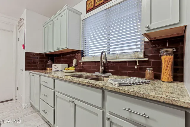 a kitchen with stainless steel appliances granite countertop a sink and cabinets