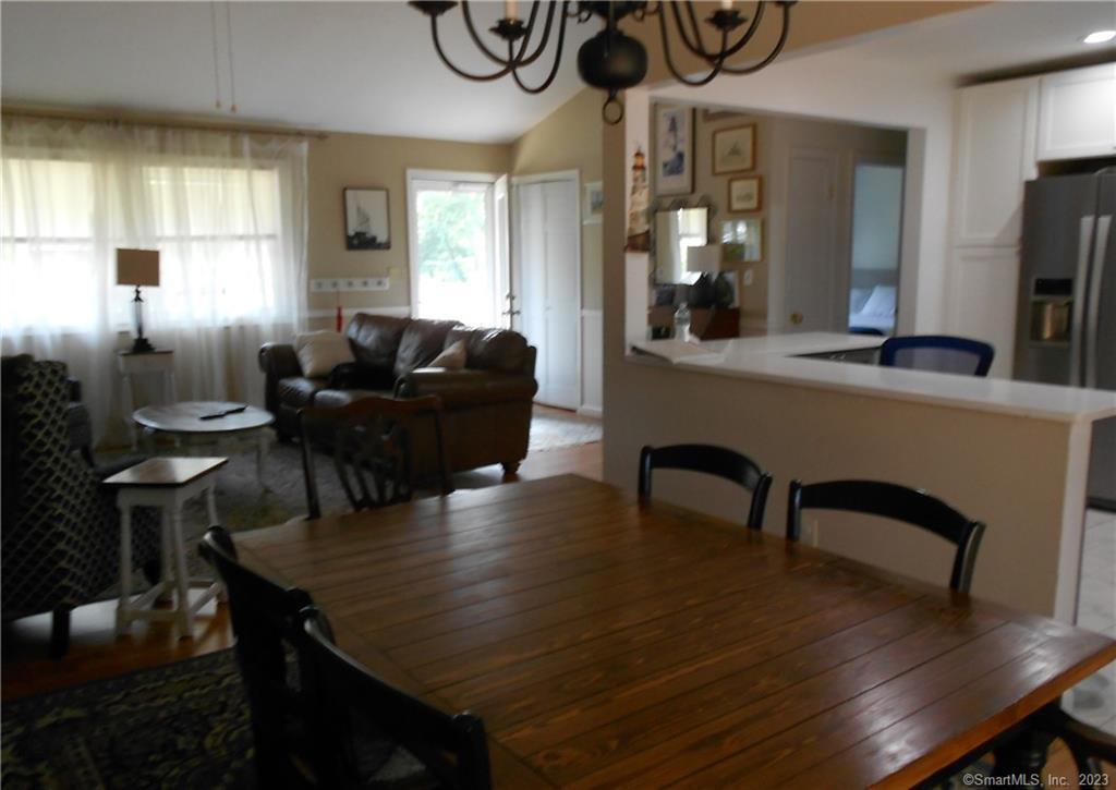 12 Allendale Road Old Saybrook, CT 06475 - Photo 11 of 36 a living room with furniture a window and a flat screen tv