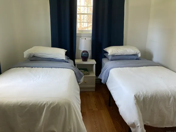 a bedroom with double bed and a window