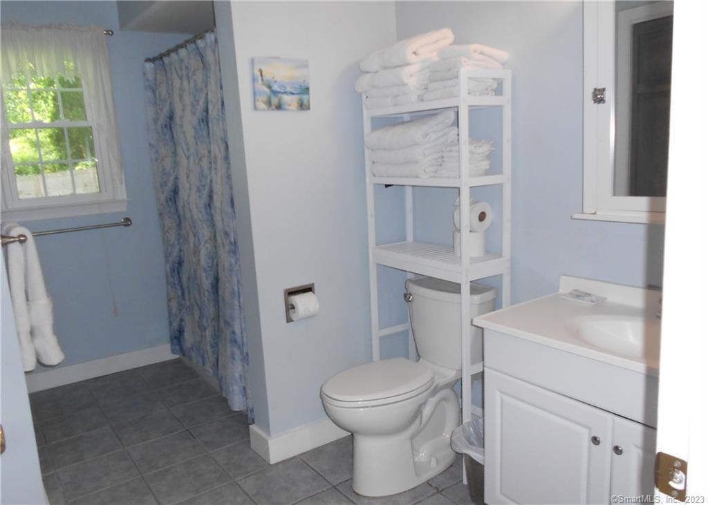 12 Allendale Road Old Saybrook, CT 06475 - Photo 16 of 36 a bathroom with a sink toilet vanity and window