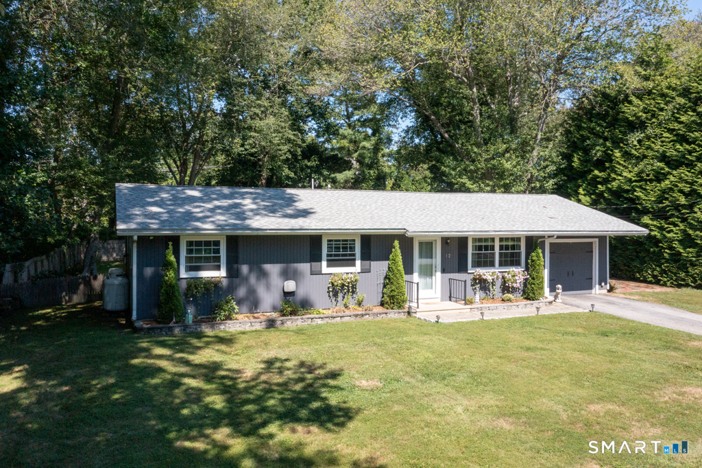 12 Allendale Road Old Saybrook, CT 06475 - Photo 2 of 36 a front view of a house with a garden patio and fire pit