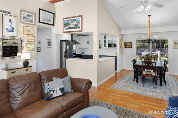 a living room with furniture kitchen view and a dining table
