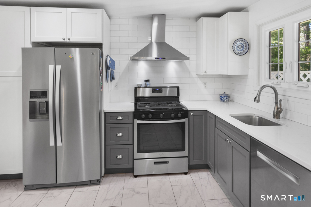12 Allendale Road Old Saybrook, CT 06475 - Photo 23 of 36 a kitchen with stainless steel appliances granite countertop a refrigerator and a stove