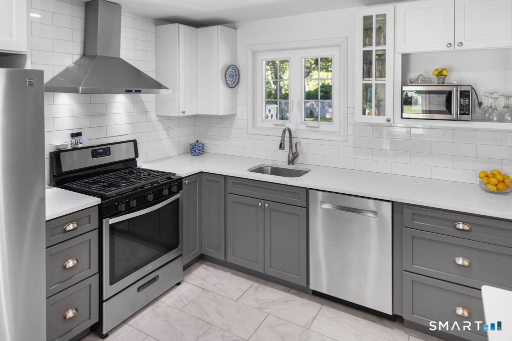 12 Allendale Road Old Saybrook, CT 06475 - Photo 25 of 36 a kitchen with stainless steel appliances granite countertop a sink stove and cabinets