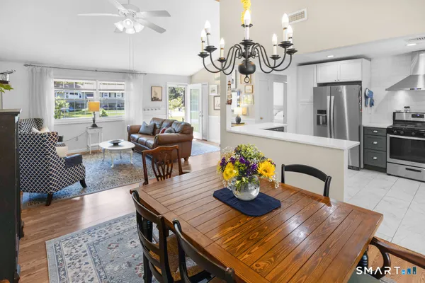 a view of a dining room with furniture and wooden floor