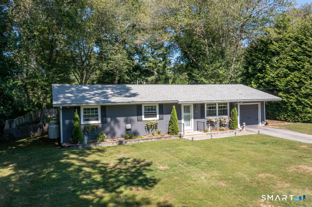 12 Allendale Road Old Saybrook, CT 06475 - Photo 4 of 36 a front view of a house with a garden and porch
