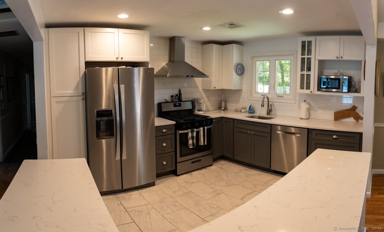 12 Allendale Road Old Saybrook, CT 06475 - Photo 6 of 36 a kitchen with stainless steel appliances granite countertop a sink a stove a refrigerator and a refrigerator